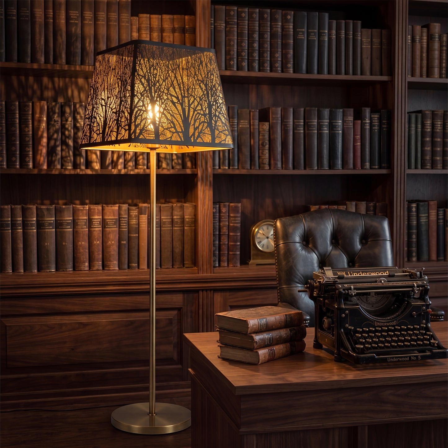 Modern square metal clip-on lamp shade on brass floor lamp, black and gold woodland tree pattern, industrial minimalist replacement lamp shade casting warm ambient glow in vintage library