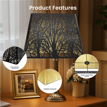 Decorative lamp with tree pattern shade on a table.
