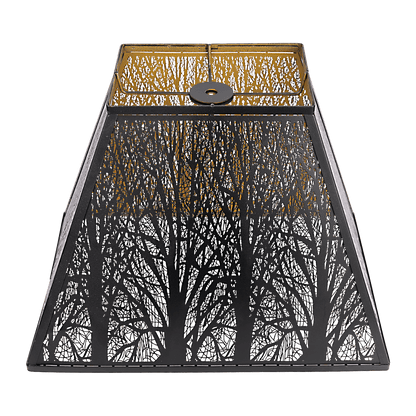 A pyramid-shaped metal lamp shade with black and gold etched forest details.
