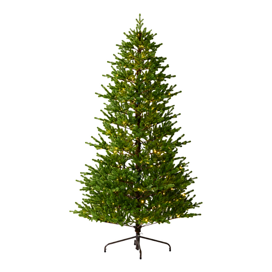 Green pre-lit artificial Christmas tree with warm white lights and a dark metal four-leg stand, isolated against a white background.
