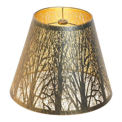 Close-up of a small metal lamp shade replacement featuring antique brass finish, golden interior, and detailed forest cutout design.
