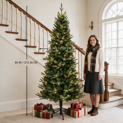 7 ft green artificial Christmas tree with warm lights beside a woman, labeled 84 inches tall and 48 inches wide.