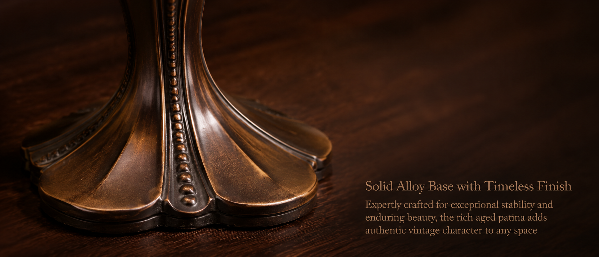 Close up of antique bronze alloy base on vintage Tiffany style table lamp with elegant carved metal details