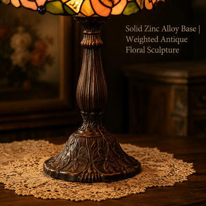 Detailed view of antique zinc alloy base on pink rose Tiffany table lamp with vintage floral carving and elegant handcrafted metal finish