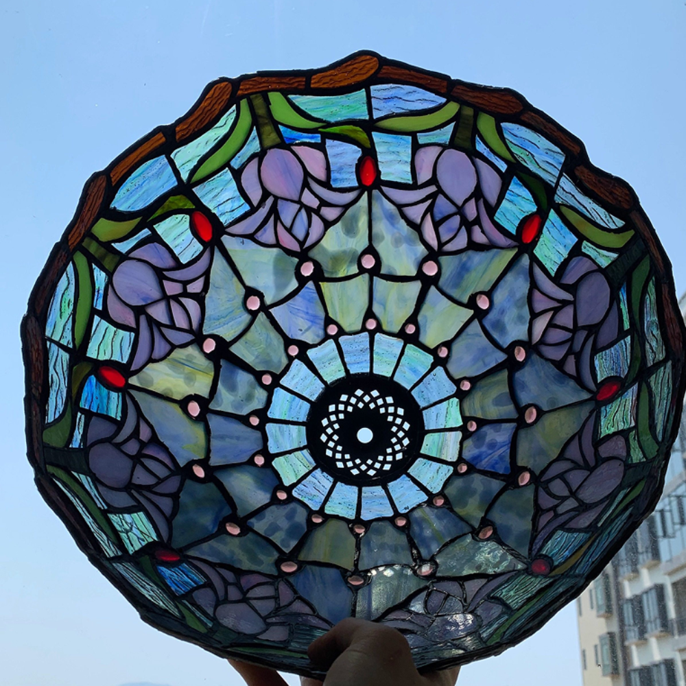 Close-up of handcrafted blue and white tulip stained glass shade with delicate floral craftsmanship