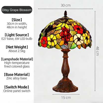 Colorful floral Tiffany table lamp featuring vibrant stained glass mosaic shade with antique bronze base in bohemian style