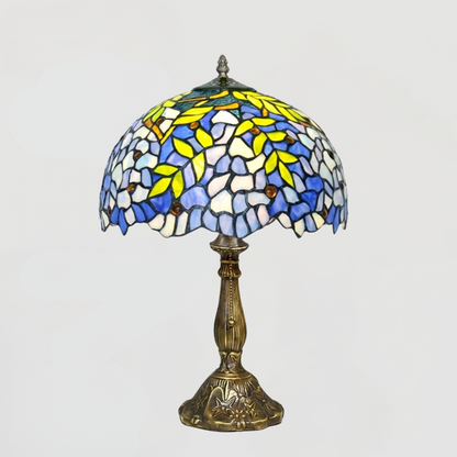 Aeelleea wisteria stained glass table lamp providing soft blue ambient lighting for a peaceful reading corner