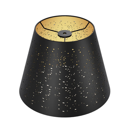 Close up of celestial star etched pattern on metal lampshade highlighting decorative craftsmanship and textured surface