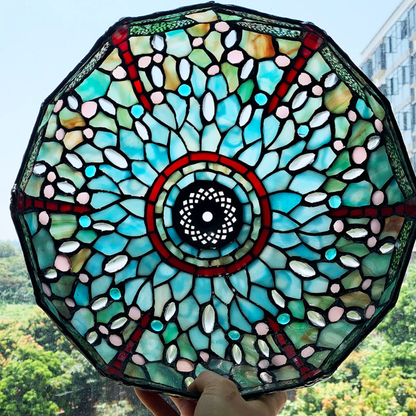 Tiffany style table lamp casting a soft serene glow through emerald and ruby dragonfly stained glass in nature inspired interior