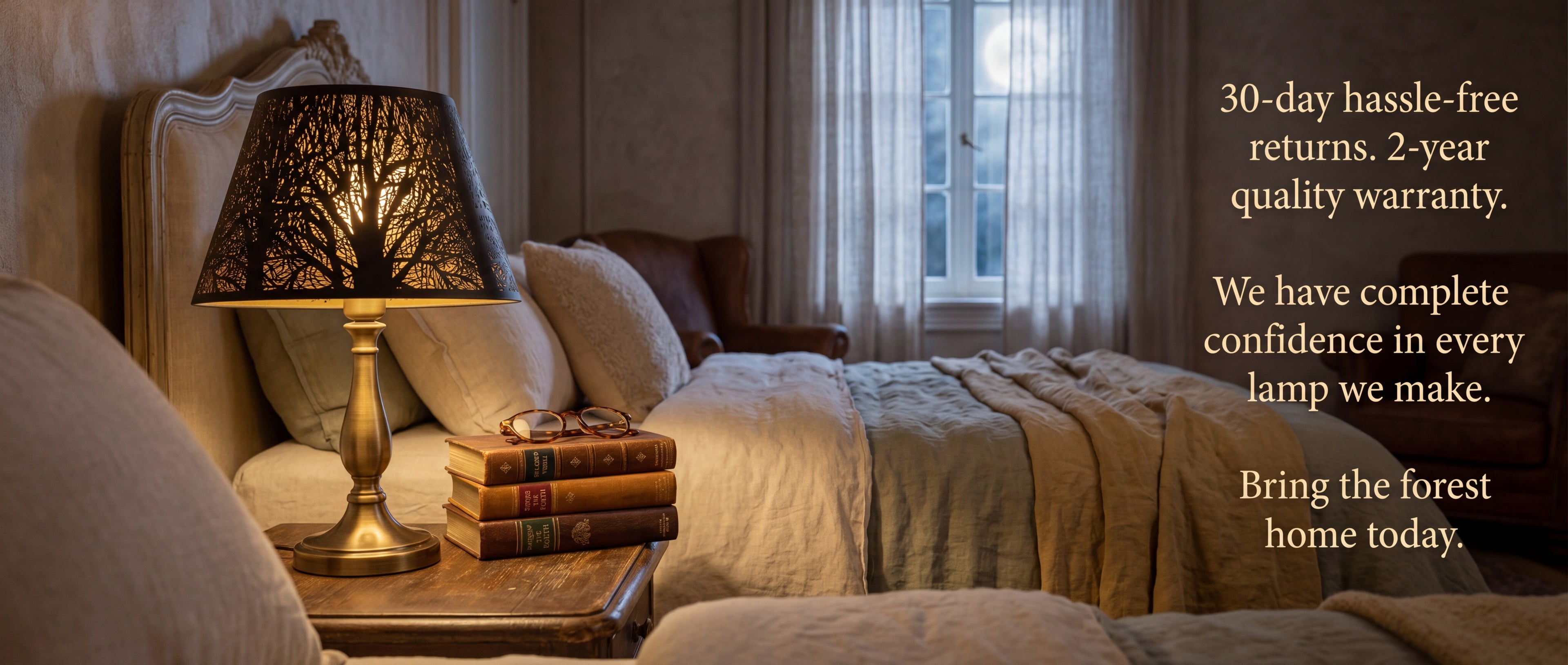 Modern Forest Etched Metal Lamp Shade - "Bring the Forest Home Today" with Quality Guarantee - "30-Day Hassle-Free Returns, 2-Year Quality Warranty, We Have Complete Confidence in Every Lamp We Make" - on Vintage Brass Table Lamp on Rustic Wood Nightstand with Stack of Antique Leather Books, Gold-Rimmed Eyeglasses, in Elegant French Provincial Bedroom with Carved Wood Upholstered Bed, Soft Cream and Sage Green Bedding, Leather Armchair, Full Moon Shining Through Sheer White Curtains, Black Metal Laser-Cut F