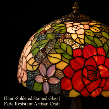 Close up view of handcrafted rose stained glass shade with colorful floral patterns on a vintage Tiffany lamp