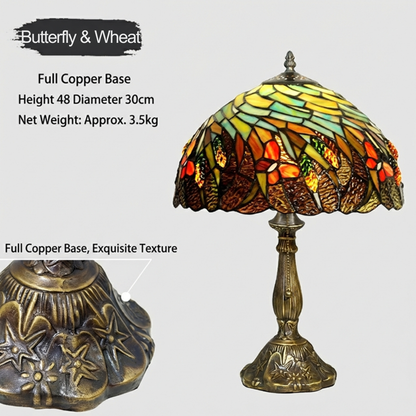 Tiffany style table lamp casting a warm autumn glow through amber stained glass with wheat and butterfly patterns in cozy interior