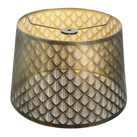 Lamp shades at home featuring a medium antique brass metal shade with detailed geometric cutouts and a warm gold interior