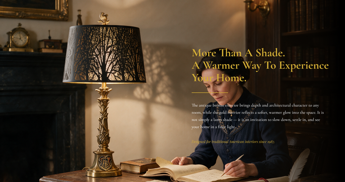 Large drum lampshade with etched tree patterns displayed on a brass table lamp beside a woman writing in a vintage study.