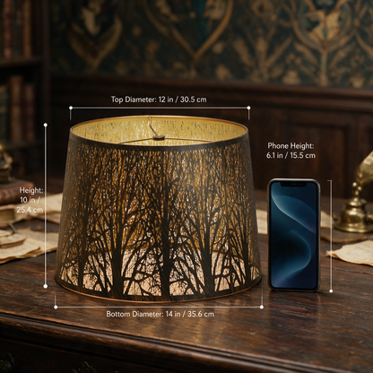 Large forest etched metal lampshade measuring 12-inch top, 14-inch bottom and 10-inch height beside a 6.1-inch phone.