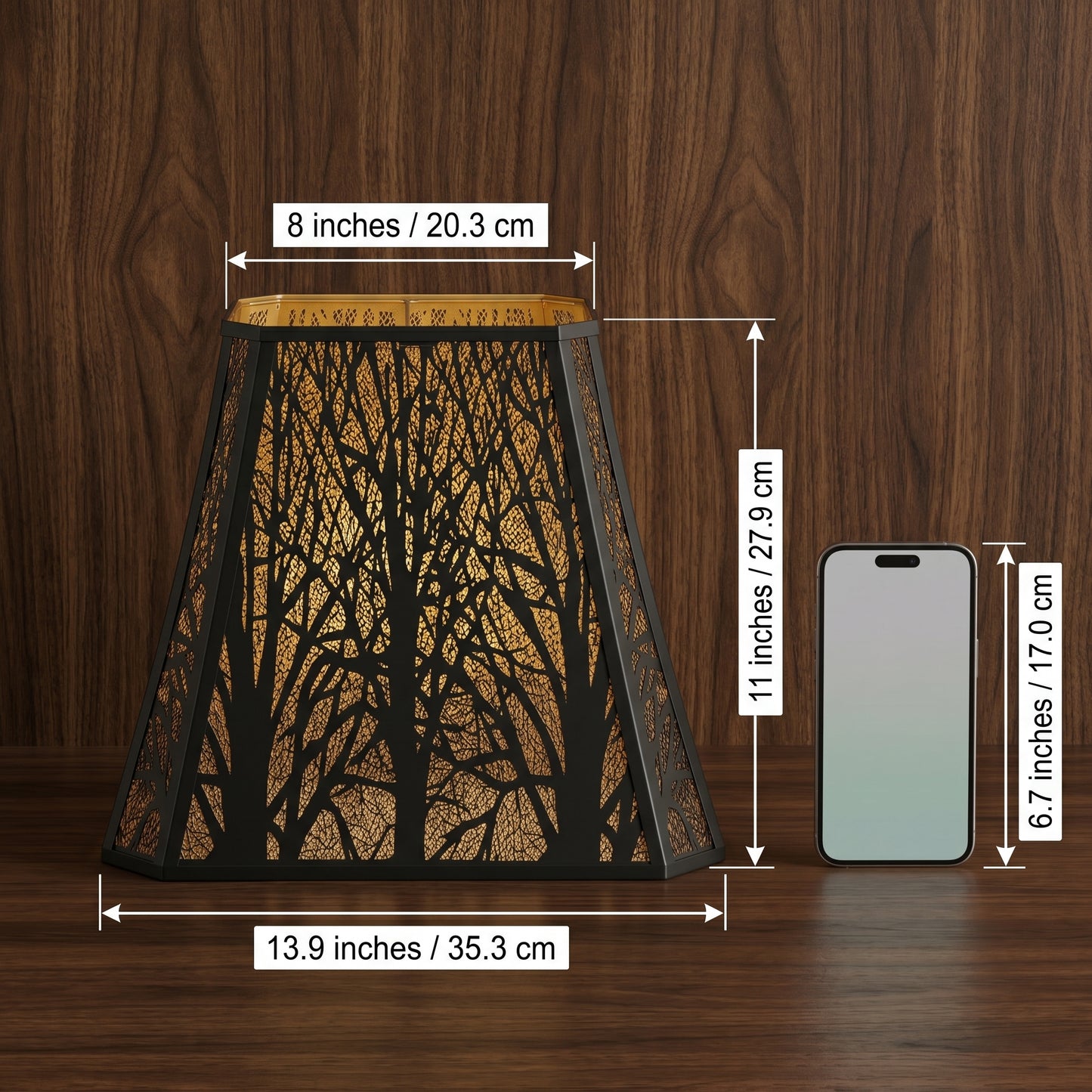 Large Rectangle Forest Etched Metal Lamp Shade Size Reference Chart - Dimensions: Top Diameter 8 inches (20.3cm), Bottom Diameter 13.9 inches (35.3cm), Height 11 inches (27.9cm) - Compared to Standard 6.7 inch Smartphone (17.0cm) - Black Metal Laser-Cut Forest Tree Branch Pattern with Warm Gold Interior Glow - Shown on Polished Wood Background - 8"x13.9"x11" Large Rectangle Replacement Lamp Shade with Standard Fitter for Floor Lamps, Table Lamps, Statement Lighting Fixtures, Decorative Lighting for Warm Amb
