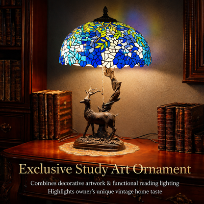 Luxury vintage Tiffany table lamp with wisteria stained glass shade displayed on an antique study desk