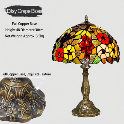 Close-up of handcrafted Tiffany stained glass shade with colorful floral mosaic pattern in red yellow and green glass pieces