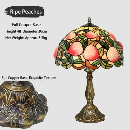Tiffany style table lamp casting warm golden peach glow through stained glass fruit inspired shade in cozy interior