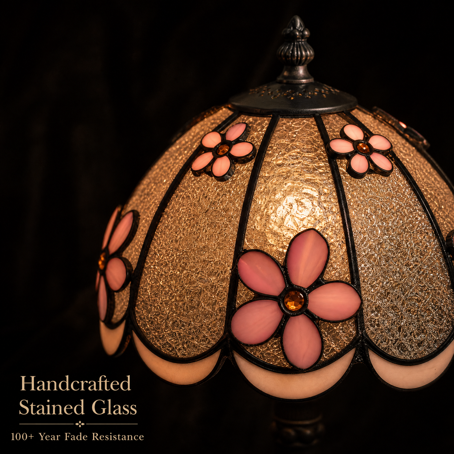 Close-up of Tiffany style bedside lamp showing pink dimensional flowers and textured stained glass shade