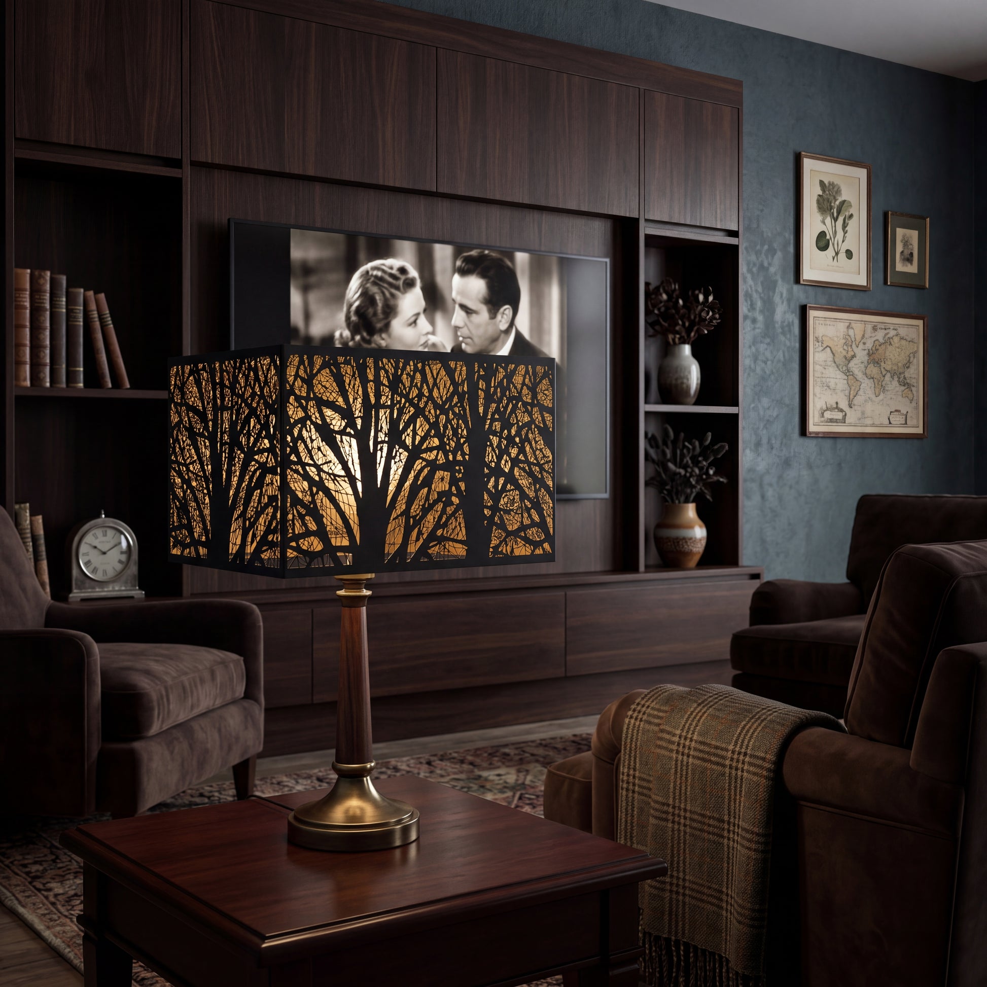 Rectangular Metal Lamp Shade with Laser-Cut Tree Pattern on Wood and Brass Table Lamp in Modern Dark Wood Home Theater Living Room - Brown Leather Sofa, Plaid Throw Blanket, Built-in Dark Walnut Media Cabinet with Flat-Screen TV Playing Classic Black-and-White Movie, Leather Books on Shelf, Brass Vintage Clock, Ceramic Vases with Dried Branches, Botanical Prints and Antique World Map Framed Art on Dark Blue-Green Textured Wall, Vintage Oriental Rug - Black Metal Exterior with Intricate Laser-Cut Bare Winter