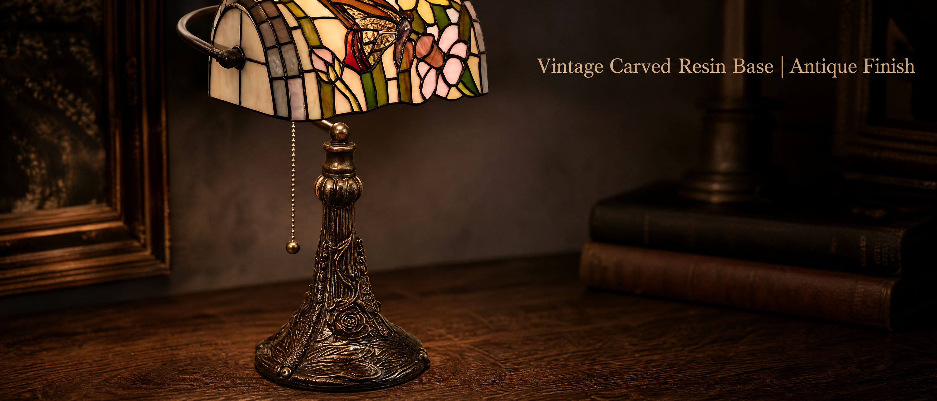 Tiffany style butterfly banker lamp with antique finish resin base featuring sculpted floral and decorative details