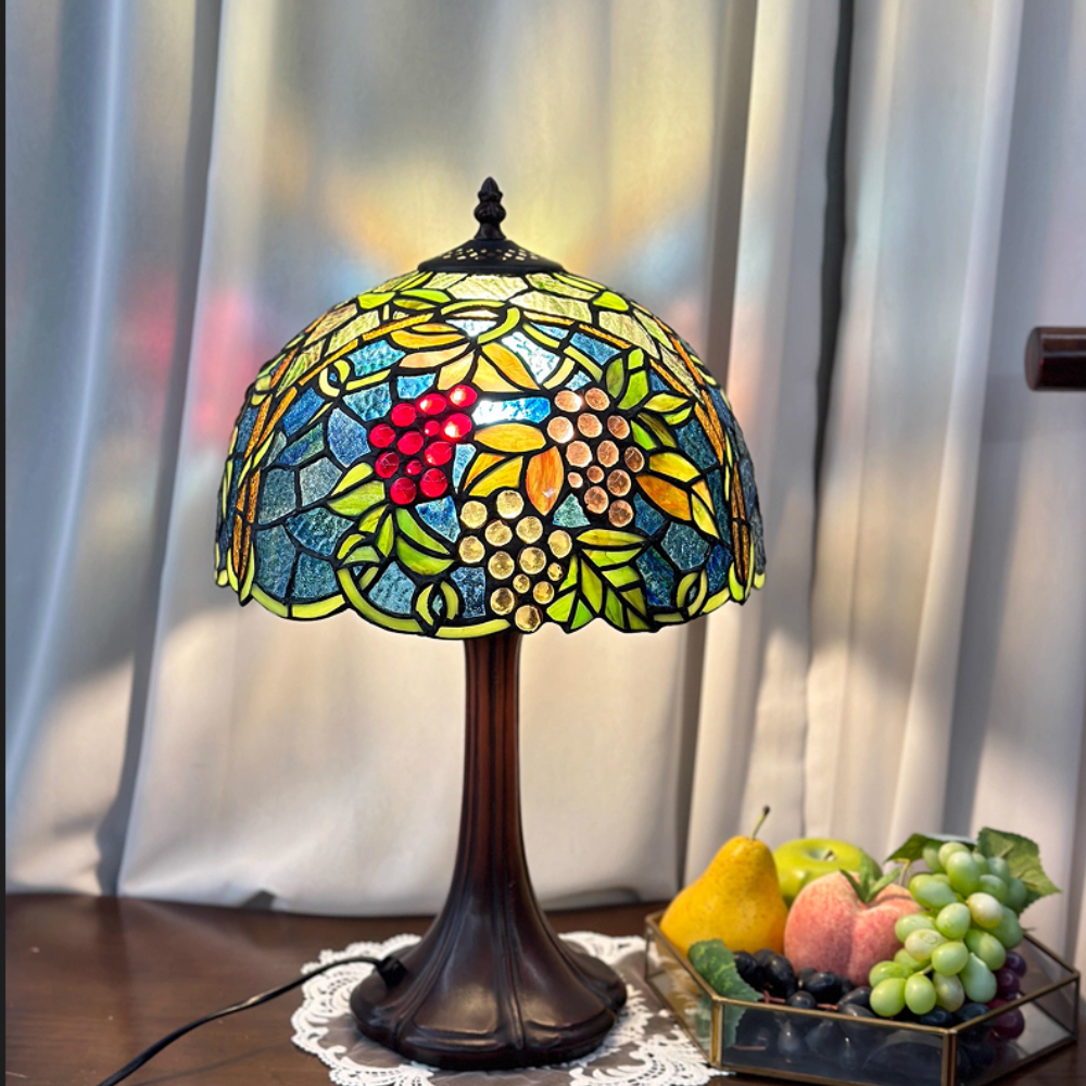 Grape cluster Tiffany table lamp featuring stained glass vineyard design with antique bronze base and warm rustic lighting