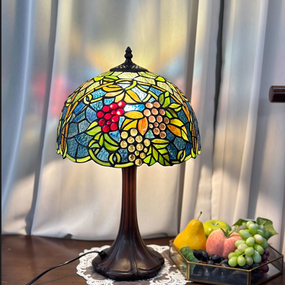 Grape cluster Tiffany table lamp featuring stained glass vineyard design with antique bronze base and warm rustic lighting