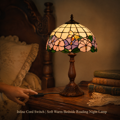 Vintage Tiffany bedside reading lamp with inline switch providing soft warm light for bedroom nightstand