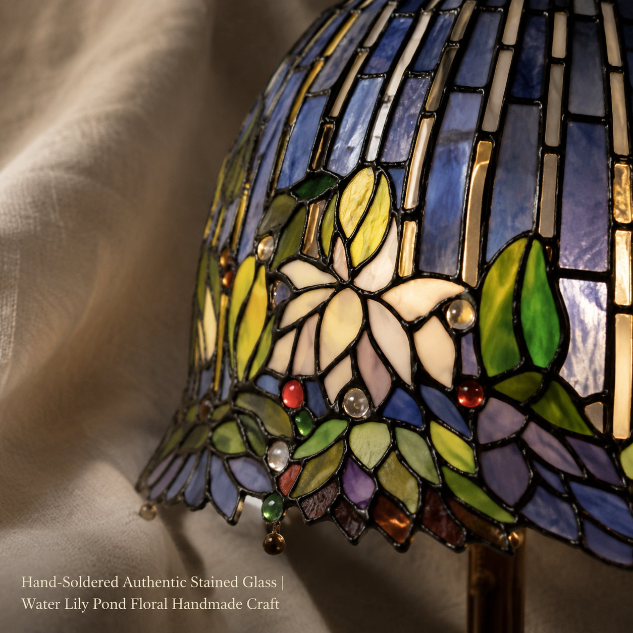 Close up view of handcrafted water lily stained glass lamp shade with floral patterns and colorful Tiffany glass details