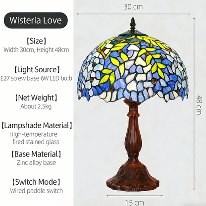 Wisteria Floral Tiffany table lamp featuring flowing blue stained glass petals with antique bronze base and romantic glow